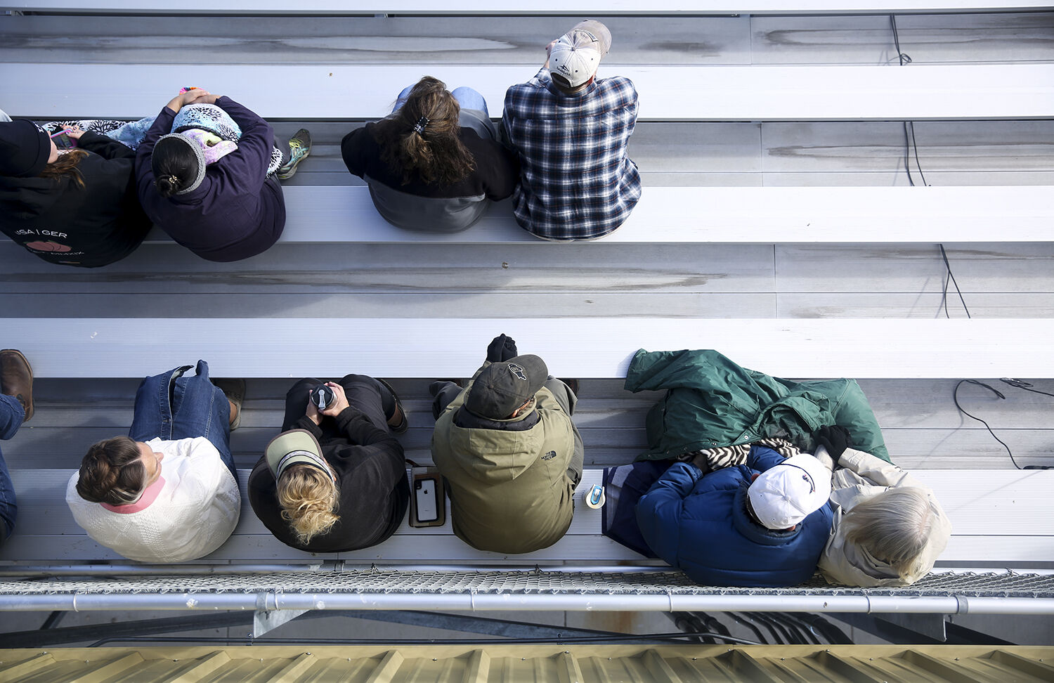 Parents spread out along the stands to watch the final marching band performance
